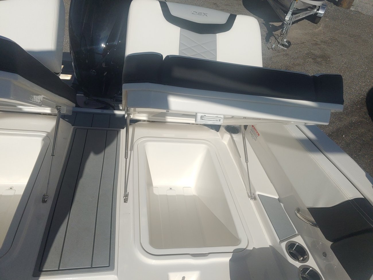 The definition of an outboard motor is a detachable engine mounted on outboard brackets on the stern of your boat.  This configuration will have only one single engine.