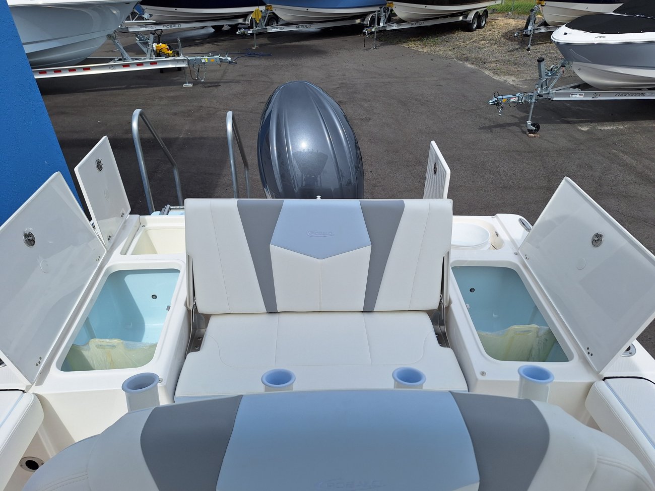 The definition of an outboard motor is a detachable engine mounted on outboard brackets on the stern of your boat.  This configuration will have only one single engine.