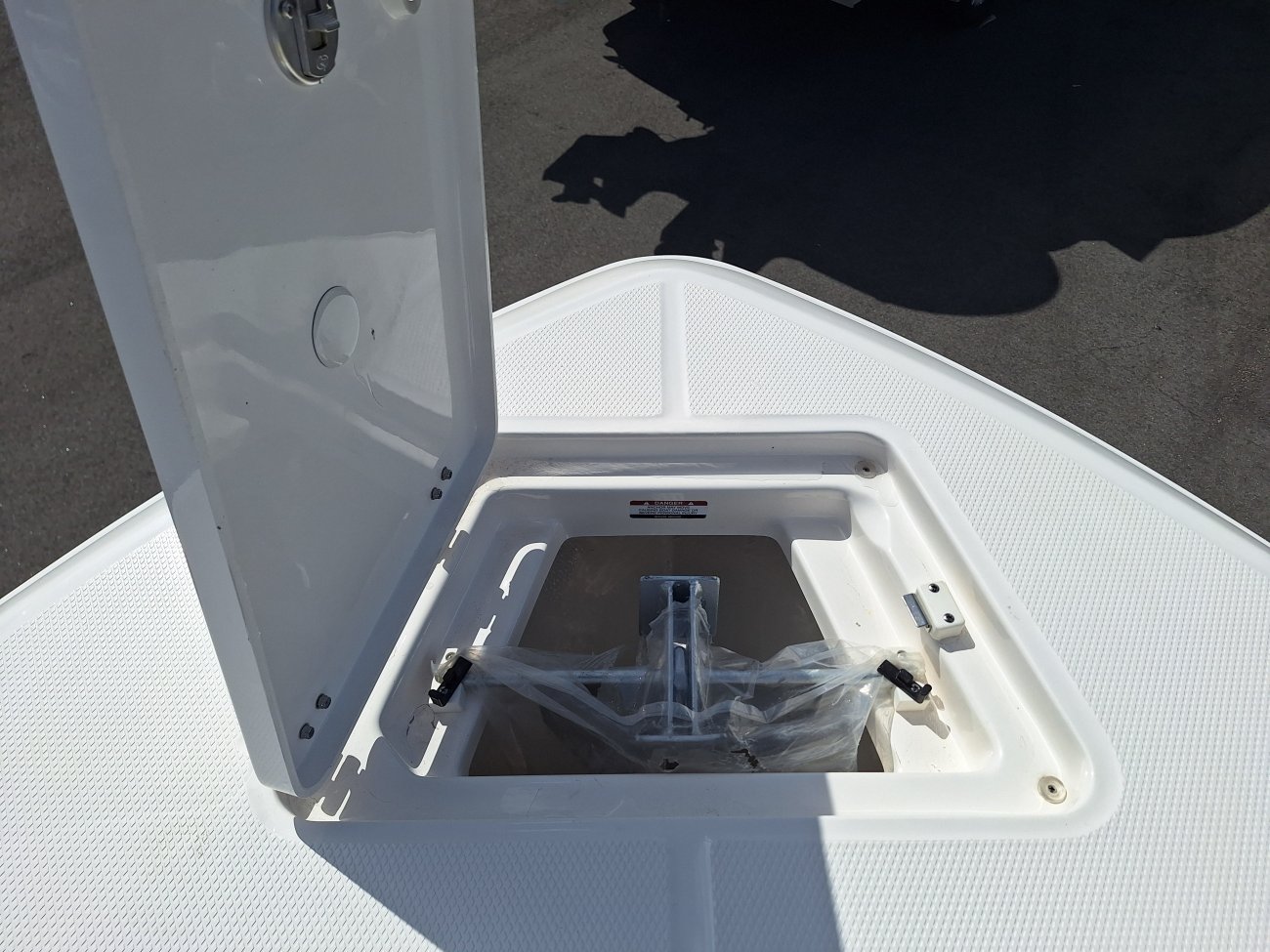 Glass fibers either loose or woven, reinforced with resin and used in the construction of many boats.