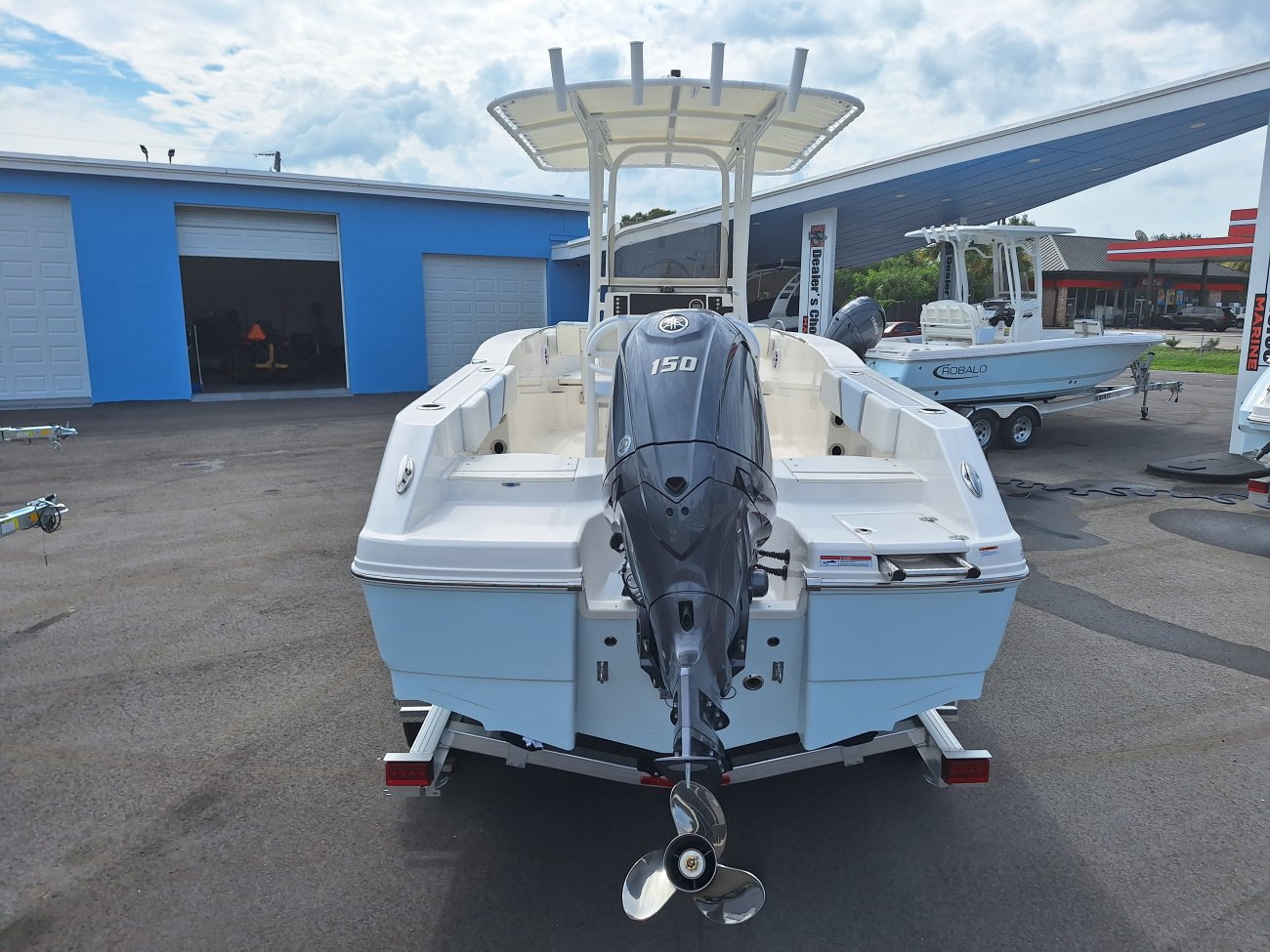The definition of an outboard motor is a detachable engine mounted on outboard brackets on the stern of your boat.  This configuration will have only one single engine.