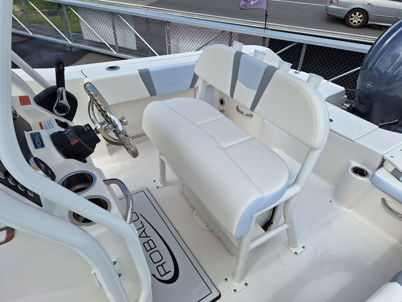 The definition of an outboard motor is a detachable engine mounted on outboard brackets on the stern of your boat.  This configuration will have only one single engine.