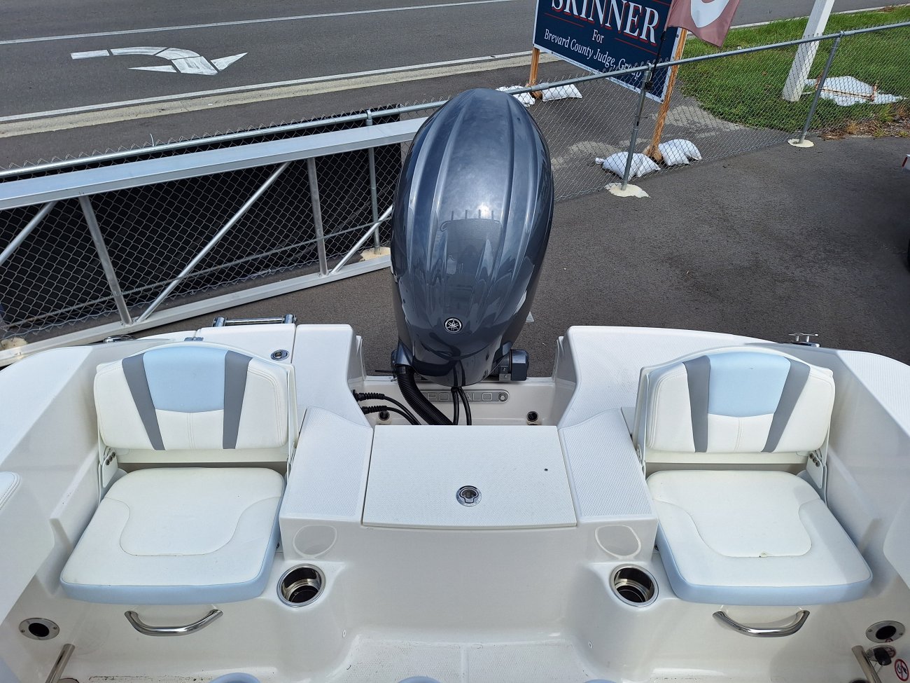 The definition of an outboard motor is a detachable engine mounted on outboard brackets on the stern of your boat.  This configuration will have only one single engine.