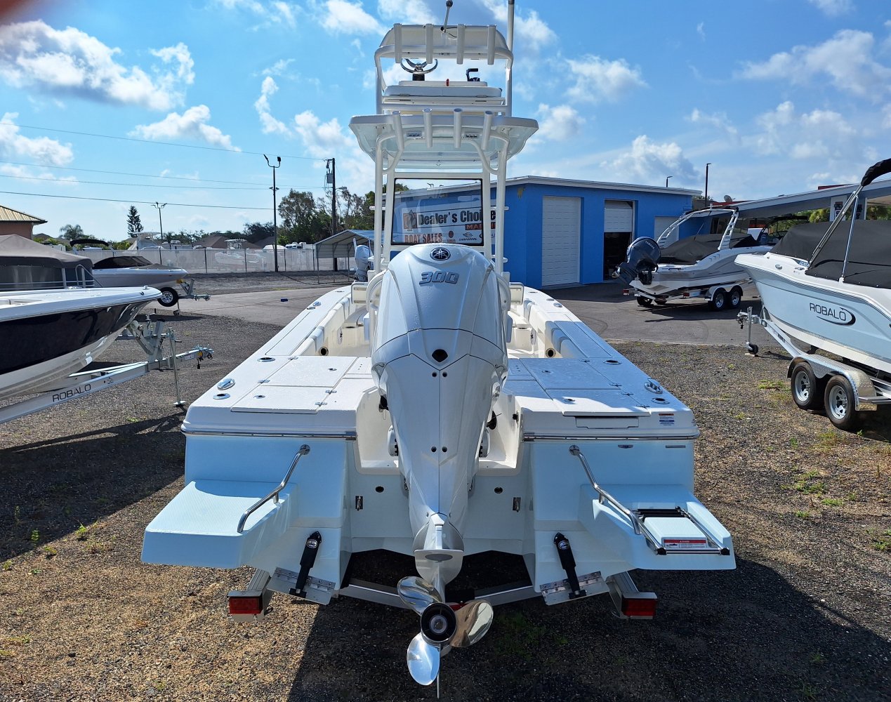 The definition of an outboard motor is a detachable engine mounted on outboard brackets on the stern of your boat.  This configuration will have only one single engine.